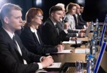 Delegates discussing topical issue while participating in political forum